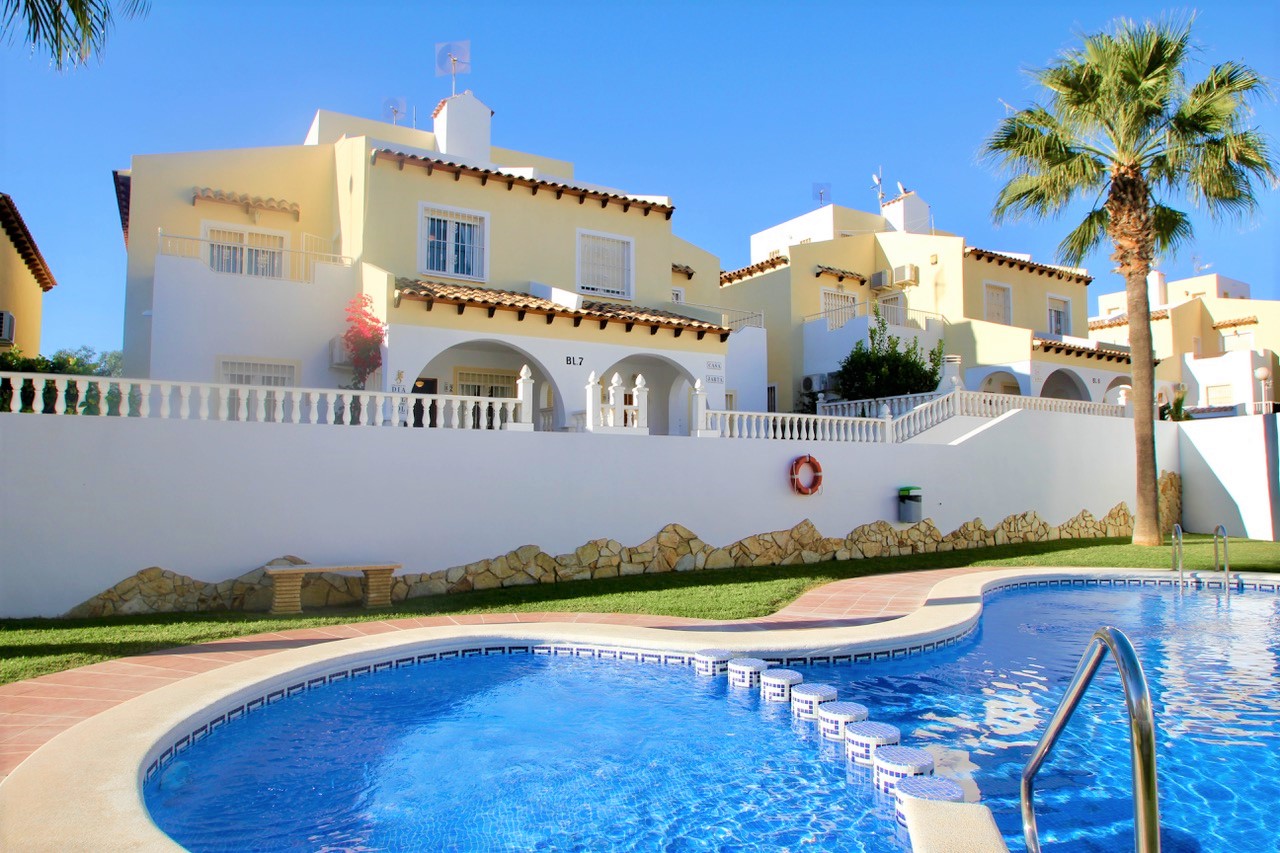 Terraced villa directly adjacent to the beautifully landscaped communal pool and garden.